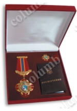 Square case with a flocked lodgment for a badge, a miniature of a badge and certificate